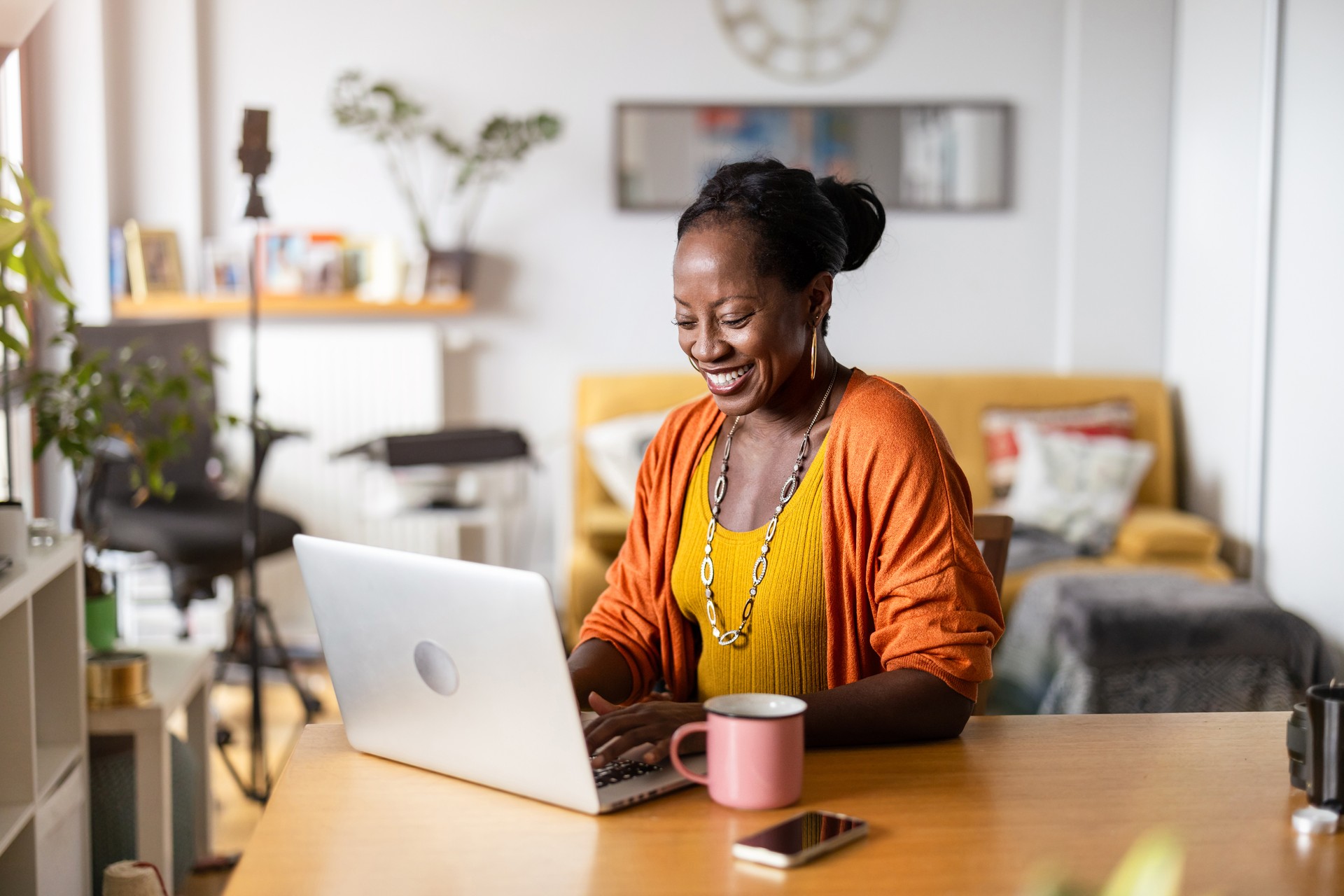 Mature woman working on laptop at home Mature woman working on laptop at home